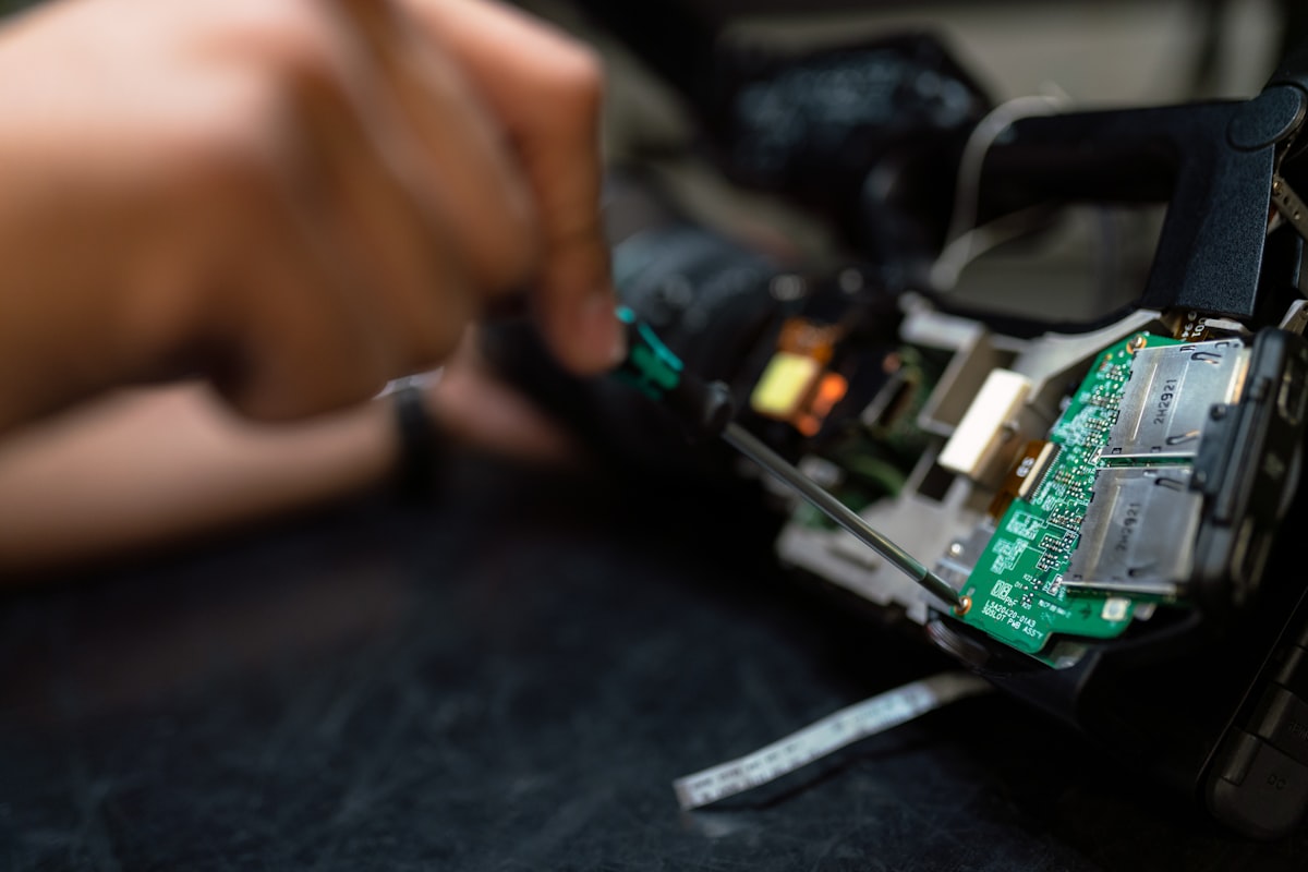An engineer repairing electronic equipment on a workbench